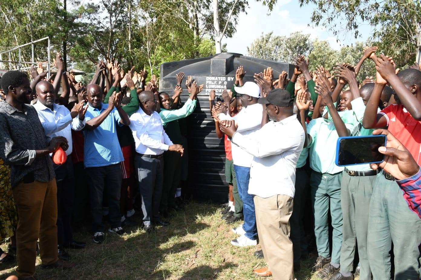 Community gathering at a water tank handover
