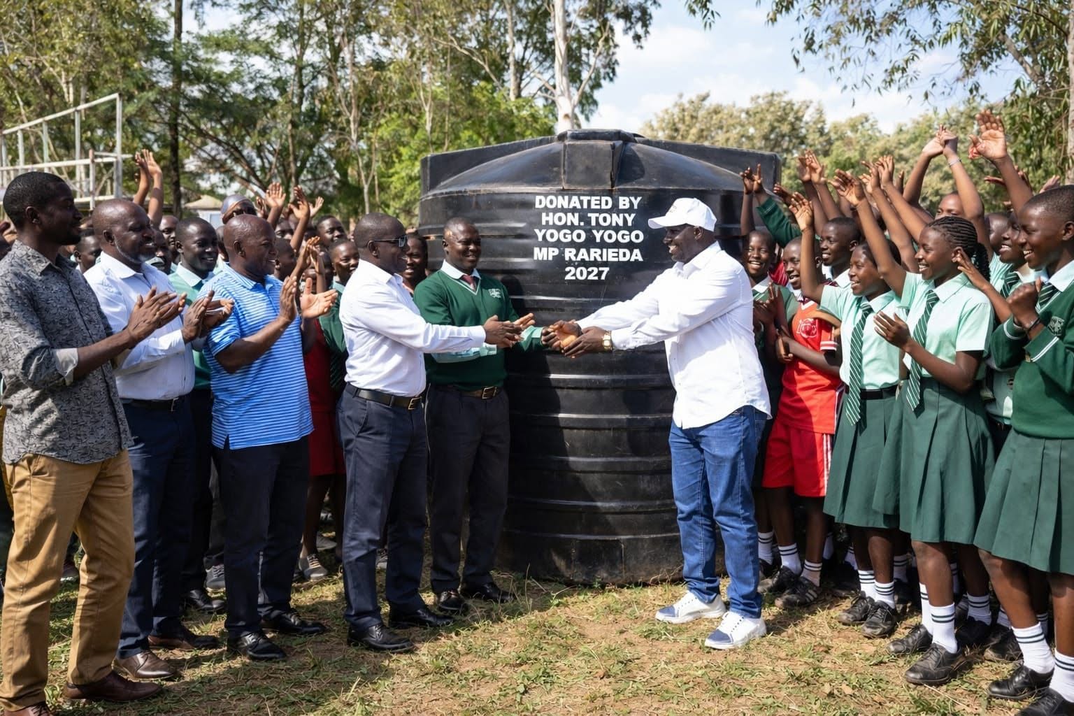 Students celebrating a new water tank in Rarieda